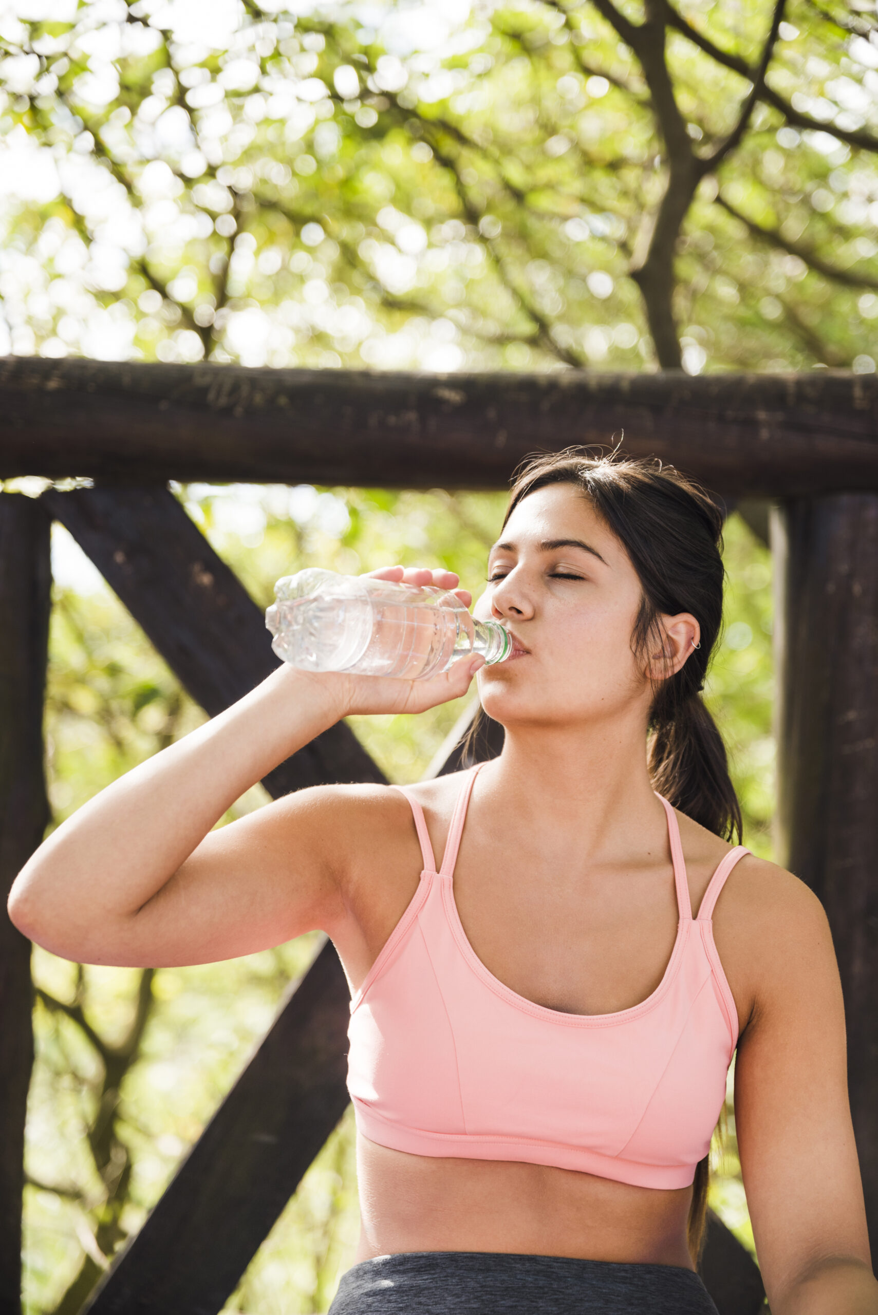 sporty-woman-drinking-outdoors